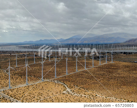 Aerial view of huge array of gigantic wind turbines spreading over the desert in Palm Springs. 65720803