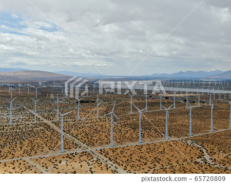 Aerial view of huge array of gigantic wind turbines spreading over the desert in Palm Springs. Aerial view of huge array of gigantic wind turbines spreading over the desert in Palm Springs. 65720809