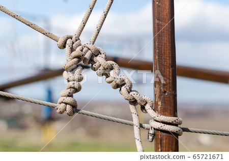 many ropes and one big knot close up 65721671