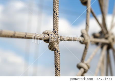 many ropes and one big knot close up 65721675