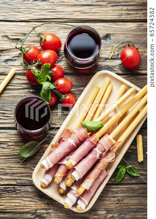 Italian antipasto with brad sticks and pork ham 65724382