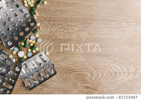 Medical Tablets on a wooden background Medical Tablets on a wooden background 65725007