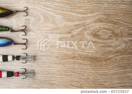 Fishing lures on a wooden background close up 65725037