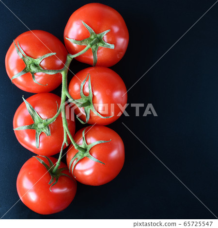 Tomato on branch top view Tomato on branch top view 65725547
