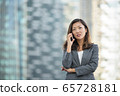 Businesswoman worried look while on voice call, using smartphone, outdoors 65728181