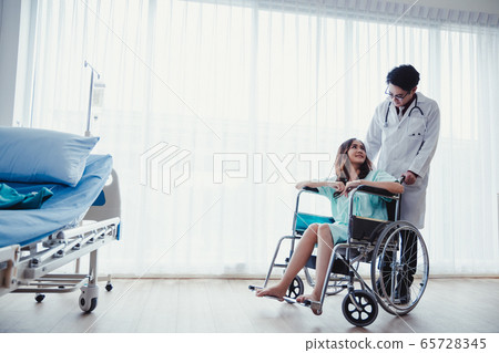 Woman patient on wheelchair in patient's room with 65728345