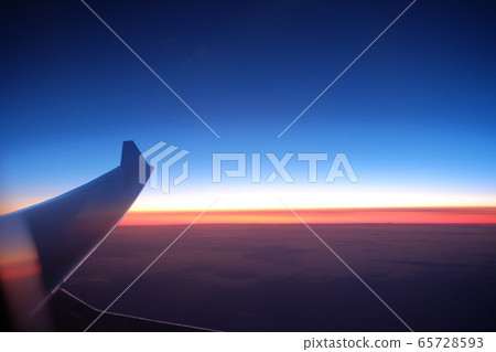 The sunrise seen from an airplane The sunrise seen from an airplane 65728593
