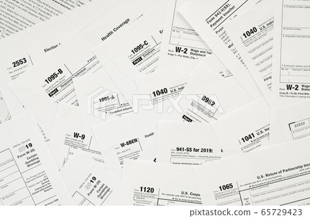 Many tax form blanks lies on table close up. Tax Many tax form blanks lies on table close up. Tax 65729423