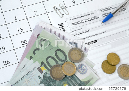 German tax form with pen and european money bills 65729576