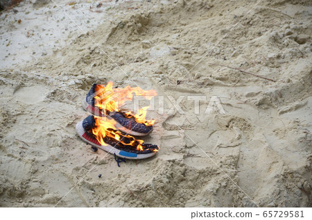 Burning sports sneakers or gym shoes on fire stand 65729581