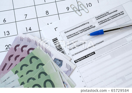 German tax form with pen and european money bills German tax form with pen and european money bills 65729584