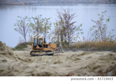 Quarry aggregate with heavy duty machinery. Quarry aggregate with heavy duty machinery. 65729603