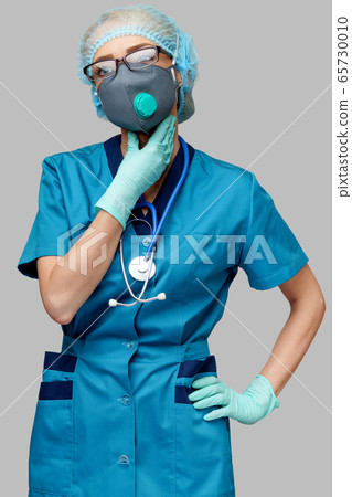 medical doctor nurse woman wearing protective mask and rubber or latex gloves - neck illness medical doctor nurse woman wearing protective mask and rubber or latex gloves - neck illness 65730010