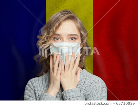Scared woman in medical mask on Romanian flag 65730059