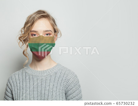 Young woman wearing a face mask with flag.  65730232