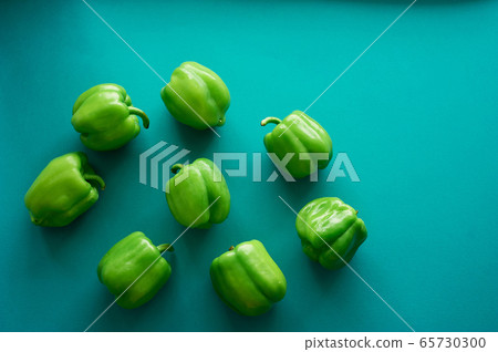 Bulgarian peppers are green on a green background. Fresh and crunchy.Vegetarian food. Bulgarian peppers are green on a green background. Fresh and crunchy.Vegetarian food. 65730300