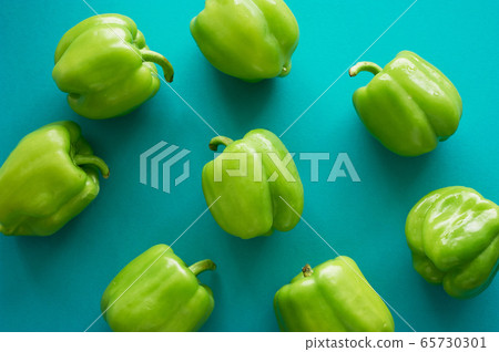 Bulgarian peppers are green on a green background. Fresh and crunchy.Vegetarian food. Texture Bulgarian peppers are green on a green background. Fresh and crunchy.Vegetarian food. Texture 65730301