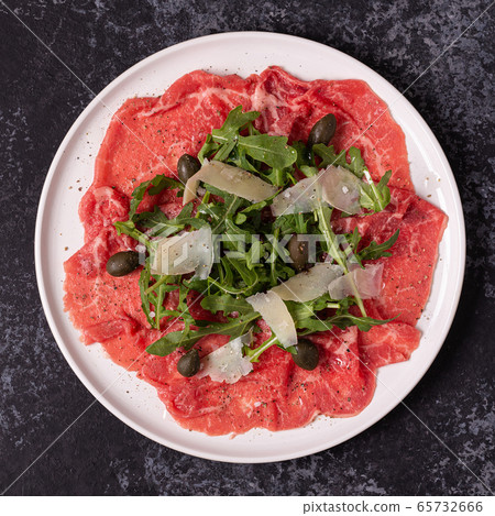 Marbled beef carpaccio with arugula, capers and Marbled beef carpaccio with arugula, capers and 65732666