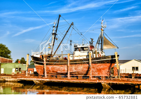 Fishing boat in a shipyard in Buesum on the North Sea in Germany 65732881