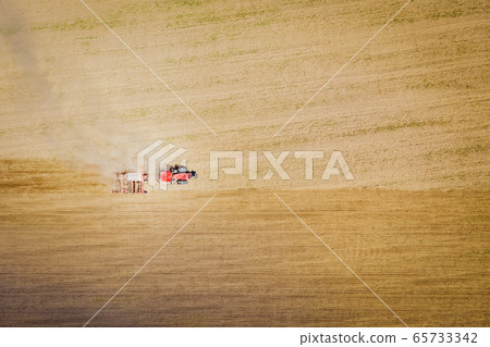 Work tractor in the field top view. Agriculture Season Prep 65733342