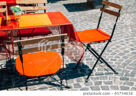 Empty restaurant terrace with table and chairs in Szentendre, Hungary Empty restaurant terrace with table and chairs in Szentendre, Hungary 65734638