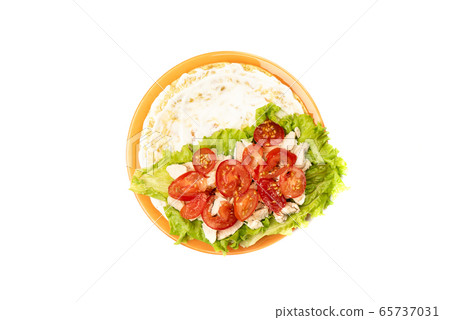Tomato slices on chicken fillet over lettuce. Tomato slices on chicken fillet over lettuce. 65737031