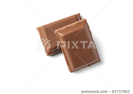 Two slices of milk chocolate. One is on the other Two slices of milk chocolate. One is on the other 65737062