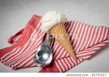 vanilla ice cream on cone with scooper vanilla ice cream on cone with scooper 65737327
