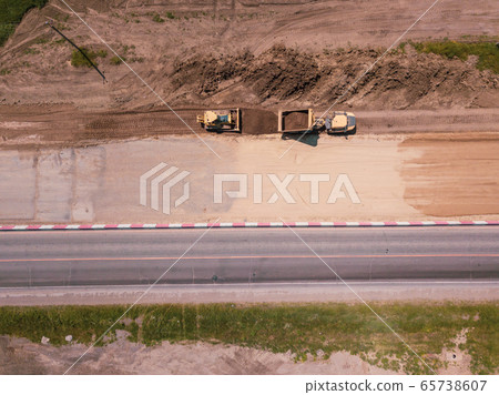 Road Construction Site near the highway with machinery, bulldozer, excavation from above. 4K video, top down view. Road Construction Site near the highway with machinery, bulldozer, excavation from above. 4K video, top down view. 65738607