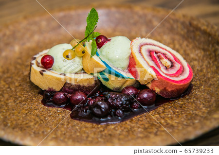 Sweet dessert with different fresh fruit. 65739233