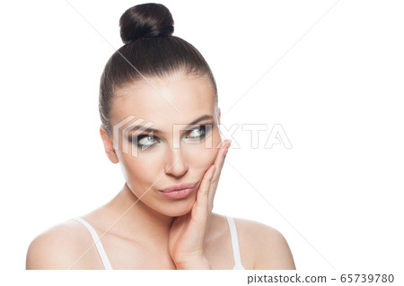Beautiful woman thinking and looking aside 65739780