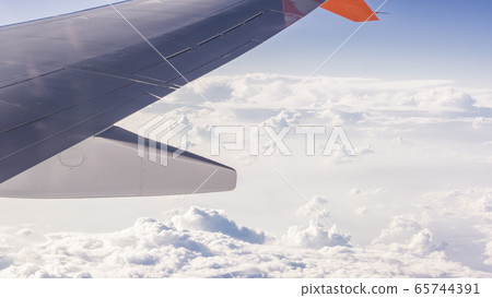Clouds from an airplane flying quite high Clouds from an airplane flying quite high 65744391