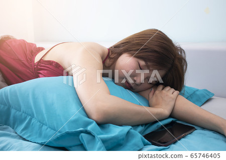 young beautiful asian woman sleeping in the bed young beautiful asian woman sleeping in the bed 65746405