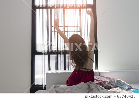 Woman doing stretching after just wake up Woman doing stretching after just wake up 65746423