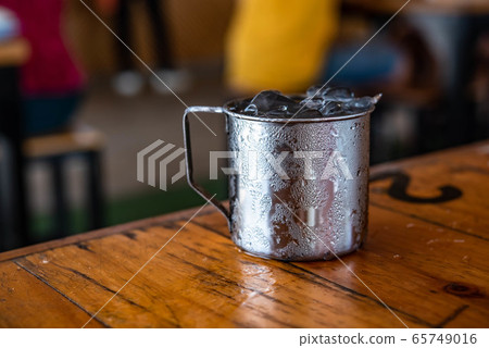 Water in aluminum glass, water droplets adhering Water in aluminum glass, water droplets adhering 65749016