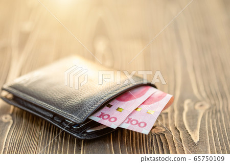 Black leather wallet with Chinese banknote on 65750109