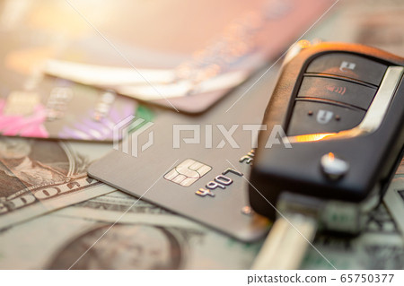 New car keys, credit card and US dollar banknote 65750377
