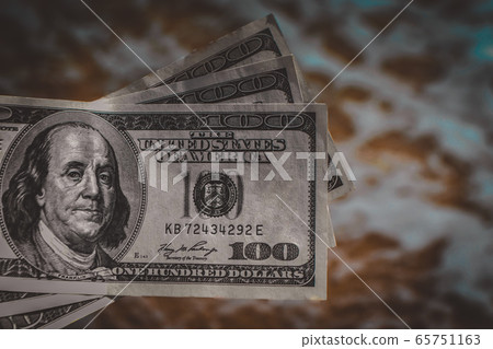 Girl holding money bill of 300 dollars on background of sea ocean 65751163
