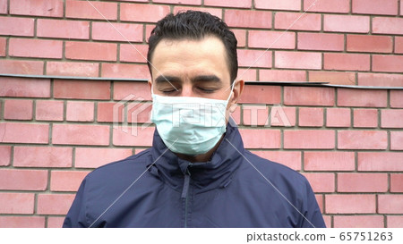 Sad man in mask standing alone with closed eyes, social distance, self isolation, quarantine concept Sad man in mask standing alone with closed eyes, social distance, self isolation, quarantine concept 65751263