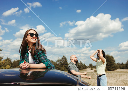 Joyful friends enjoy vacation traveling by car 65751396