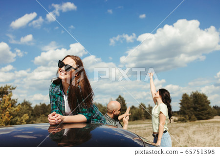 Three friends enjoying vacation travel by car 65751398