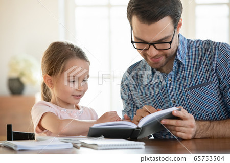 Caring dad teach small preschooler daughter reading Caring dad teach small preschooler daughter reading 65753504