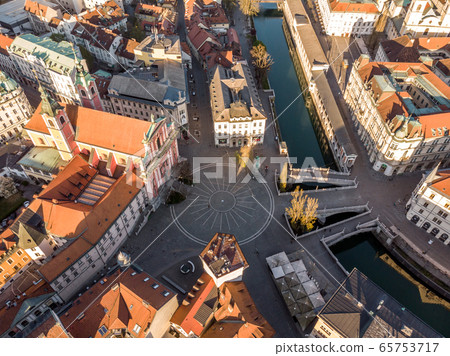 Aerial drone view of Preseren Squere and Triple Bridge over Ljubljanica river,Tromostovje, Ljubljana, Slovenia. Empty streets during corona virus pandemic social distancing measures Aerial drone view of Preseren Squere and Triple Bridge over Ljubljanica river,Tromostovje, Ljubljana, Slovenia. Empty streets during corona virus pandemic social distancing measures 65753717