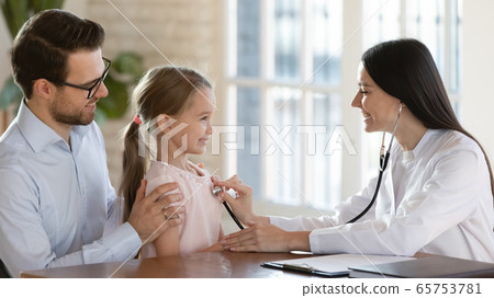 Female doctor listen to child heartbeat at consultation Female doctor listen to child heartbeat at consultation 65753781
