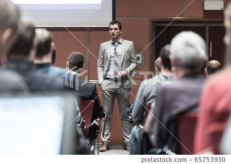 Business speaker giving a talk at business conference meeting event. Business speaker giving a talk at business conference meeting event. 65753930