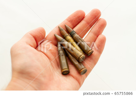 man holds ammunition for Kalashnikov assault rifle in his hand 65755866