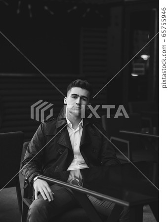 stylish handsome young man sitting in cafe stylish handsome young man sitting in cafe 65755946
