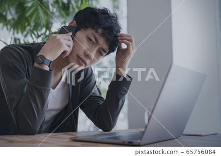 Men frowning while talking on a smartphone Men frowning while talking on a smartphone 65756084