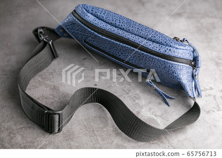 Waist bag made of blue leather, banana on a gray 65756713