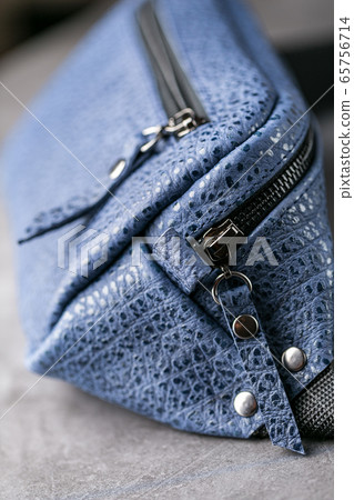 Waist bag made of blue leather, banana on a gray Waist bag made of blue leather, banana on a gray 65756714